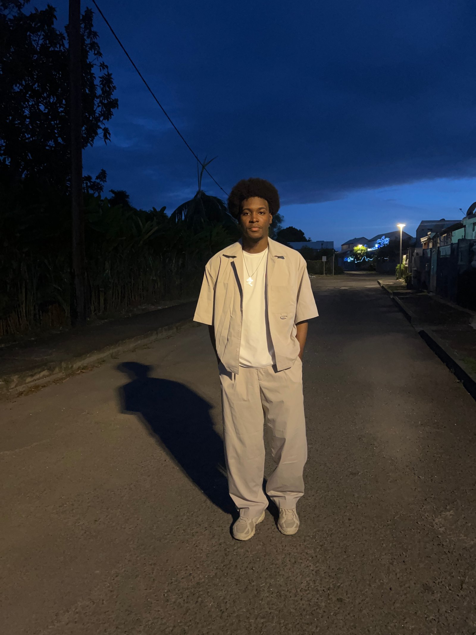 Jeanine White smiling in a red plaid shirt and tortoise shell glasses
